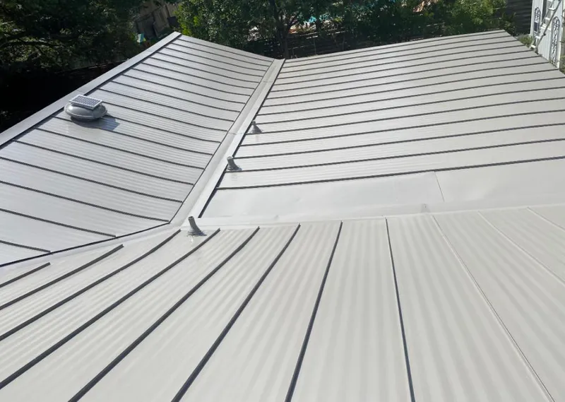 Solar attic fan installed on a metal roof for Roof Ventilation in Dickson
